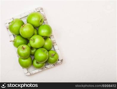 Green healthy organic apples in vintage box on wood background