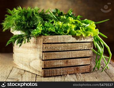 green herbs in wooden box