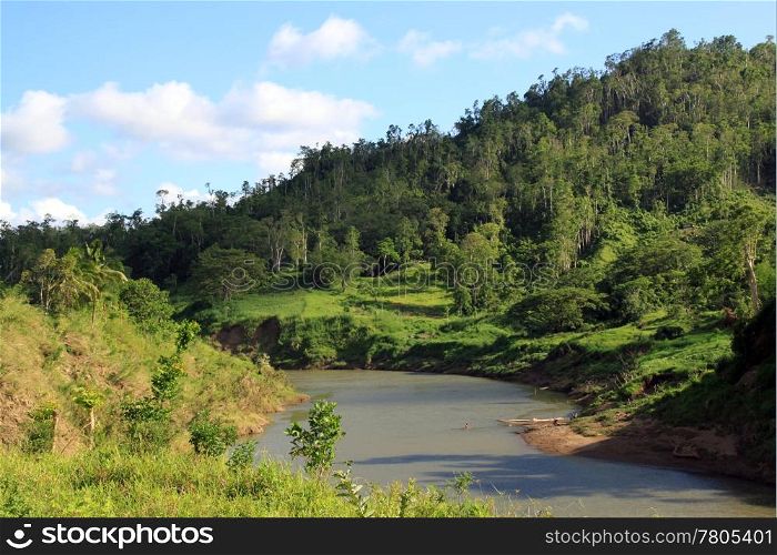Green hill, shadow and river in rural area of Fiji