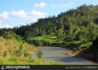 Green hill, shadow and river in rural area of Fiji