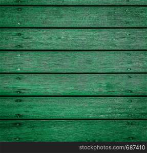 Green horizontal wooden texture for background or mockup. Rustic painted wood texture close up. Barn wall or fence. Flat wood banner, billboard or signboard. Colorful horizontal wooden texture for background or mockup.