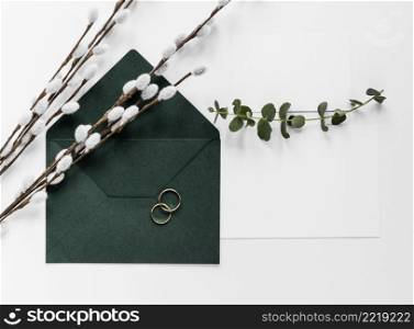 green invitation card with cotton branches