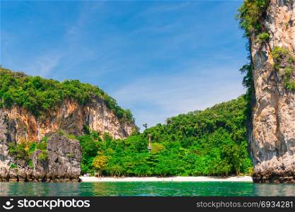 green island with steep cliffs view from the sea to the island of Hong, Thailand