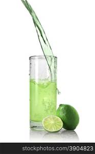 green juice with lime pouring into glass isolated on white