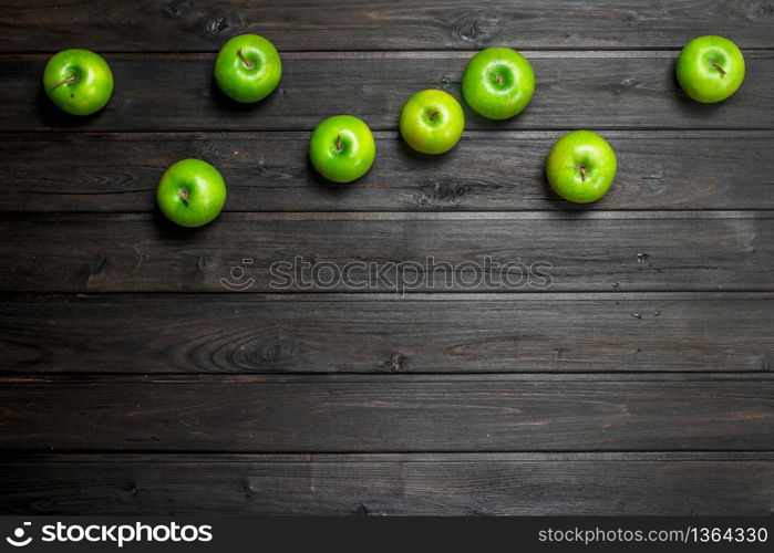 Green juicy apples. On wooden background. Green juicy apples.