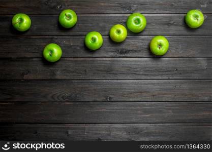 Green juicy apples. On wooden background. Green juicy apples.