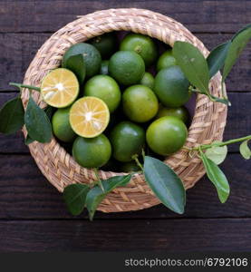 Green Kumquat fruit on wooden background, a popular agriculture product of Vietnam, rich vitamin c, healthy fruit