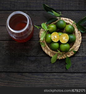 Green Kumquat fruit on wooden background, a popular agriculture product of Vietnam, rich vitamin c, healthy fruit