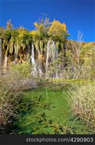 Green lake under Plitvice waterfall in national park of Croatia