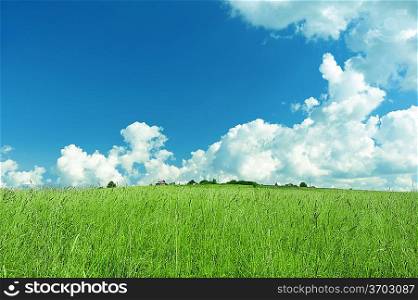 Green landscape with cloudy sky