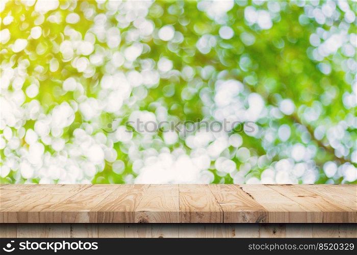 green leaf bokeh blurred and wood table for nature background