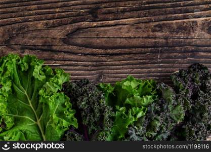 green leafy kale vegetable isolated on wooden table background. green leafy kale