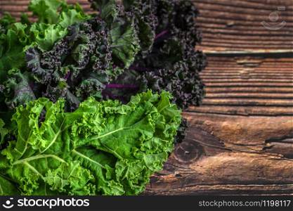 green leafy kale vegetable isolated on wooden table background. green leafy kale