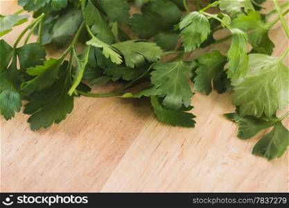 green leaves of parsley isolated on chopping board
