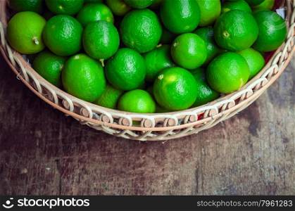 Green lemon in rattan basket