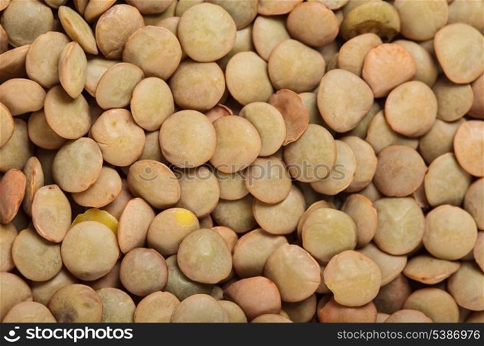 green lentils heap closeup as a background