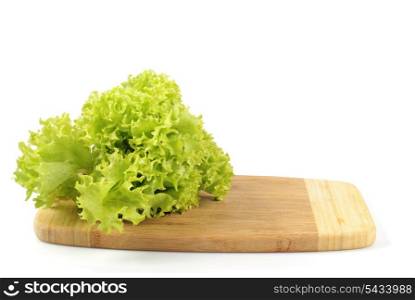 Green lettuce on hardboard in kitchen. Isolated on white