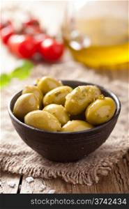 green marinated olives in bowl