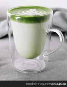 Green matcha latte in glass close up