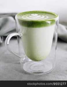 Green matcha latte with pistachios close up