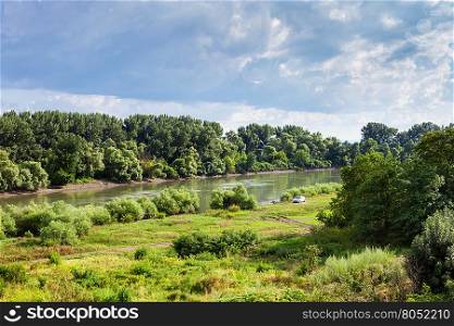 green meadow along Kuban river in summer day before rain near Slavyansk-na-Kubani town, Caucasus, Russia