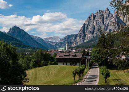 Green Meadow and Typical Houses among Mountains Scenery in Summer Time: Cortina D&rsquo;Ampezzo