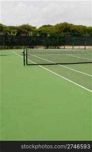 green modern hardcourt tennis (surrounded by tropical nature)