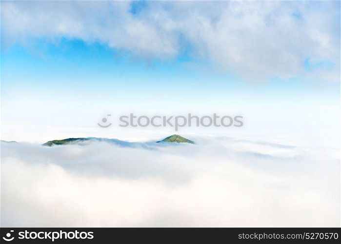 Green mountain peak in the ocean of clouds