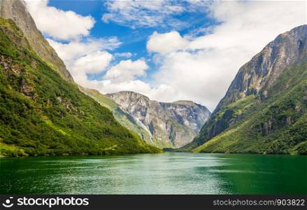 Green mountain walls along narrow Naeroy fjord, Aurlan, Sogn og Fjordane county, Norway