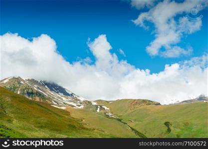 Green mountains with snow caps in June, Caucasus, Georgia