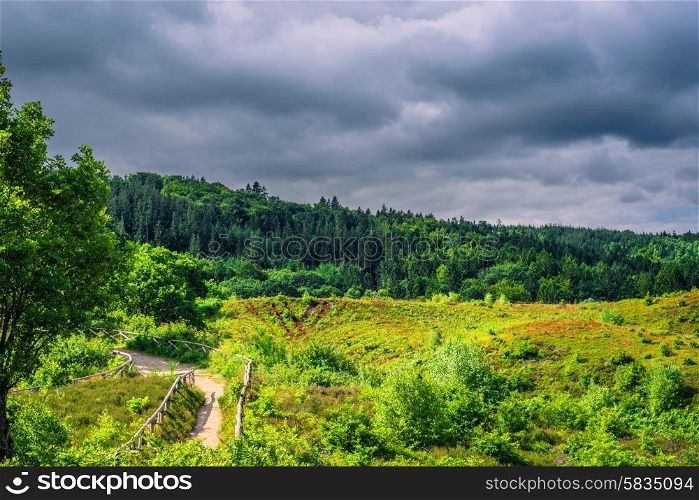 Green nature in Denmark with dark clouds in the summer