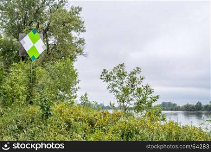 green navigational sign on the right shore of Missouri River