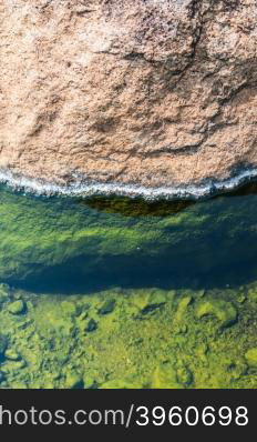 green on stone of hot spring pond closeup