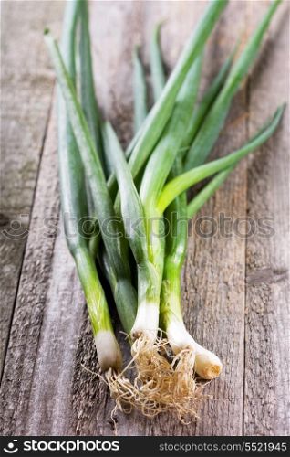 green onion on wooden table