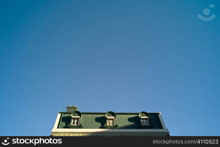 Green painted rooftop and blue sky, Lisbon, Portugal
