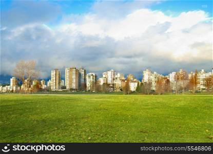 Green park with skyscrapers on the background. Vancouver, Canada