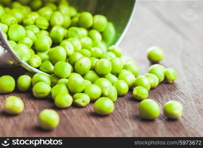 Green pea scattered on the wooden table. Green pea