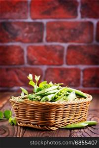 green peas in basket and on a table
