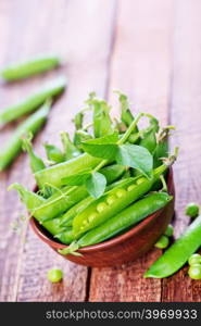 green peas in bowl and on a table