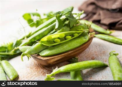 green peas in wooden bowl on a table