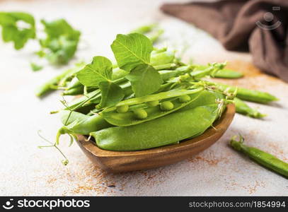 green peas in wooden bowl on a table