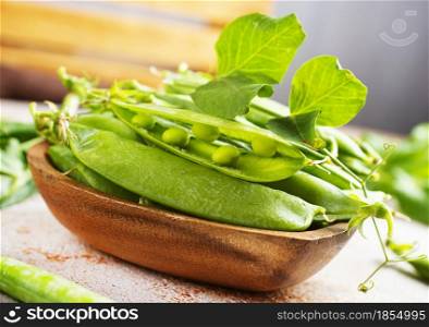 green peas in wooden bowl on a table