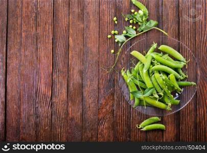 green peas on plate and on a table