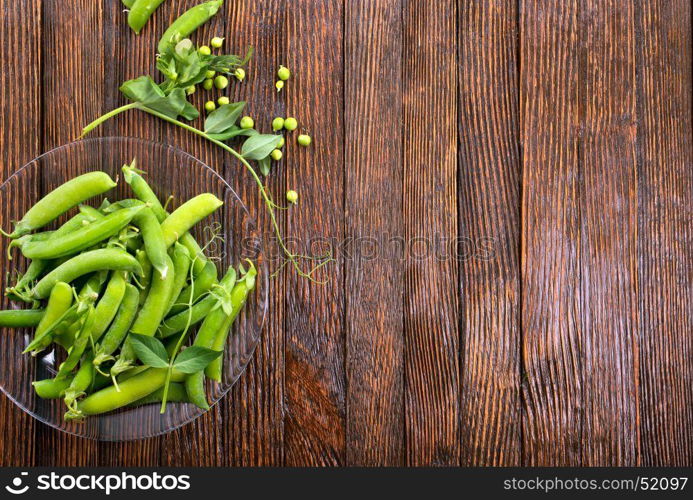 green peas on plate and on a table