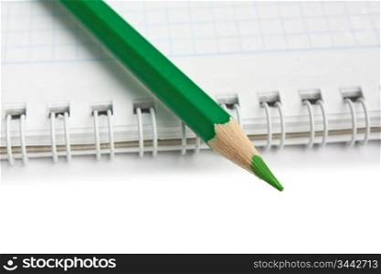 green pencils and notebook isolated on a white background