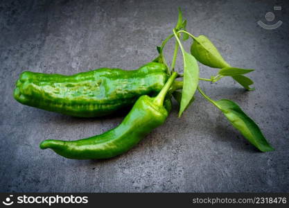 Green pepper with≤aves over dark background. Green pepper with≤aves over dark