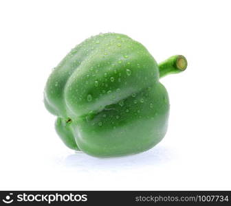 Green pepper with drops of water on white background