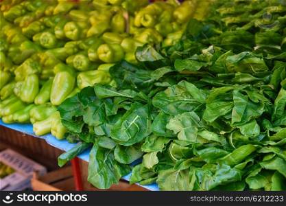 green peppers and spinach lie on counter