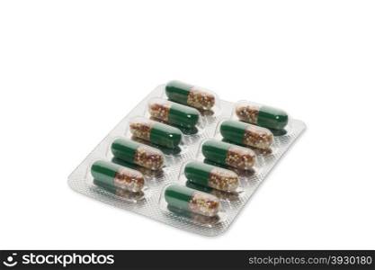 Green pills in a blister pack on white background. Green pills in a blister package on white background