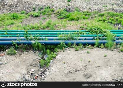 Green pipes on a ground outdoors